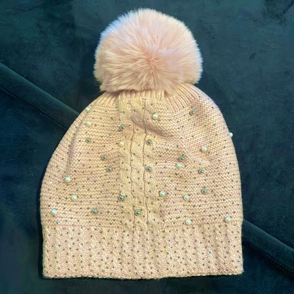 Beautiful pink woman’s beanie with soft pom pom and pearl details